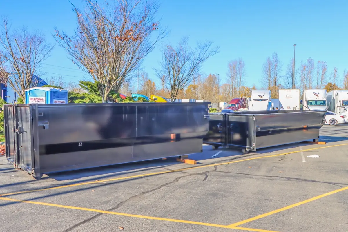 Professional dumpster rental service with roll-off container on residential driveway in Red Wing